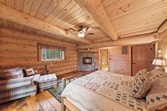 bedroom with rustic walls, ceiling fan, beamed ceiling, hardwood / wood-style floors, and wood ceiling