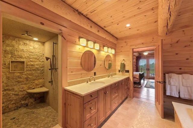 bathroom featuring vanity, a shower, wooden ceiling, wooden walls, and tile patterned flooring