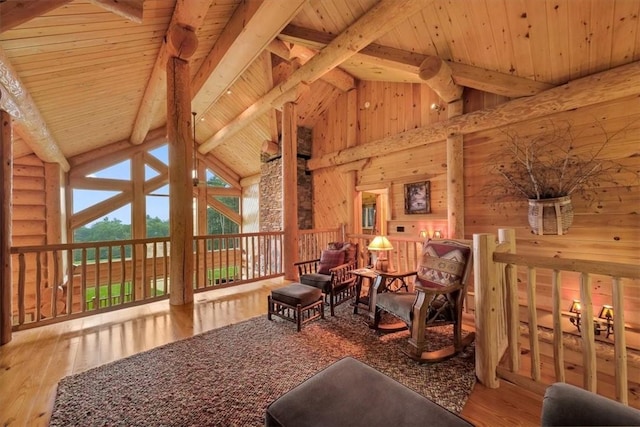 sitting room featuring beamed ceiling, hardwood / wood-style flooring, high vaulted ceiling, and wooden ceiling