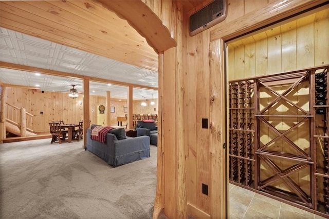 wine room with light carpet and wooden walls