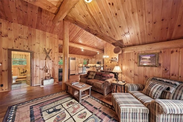 living room with hardwood / wood-style floors, lofted ceiling with beams, wood walls, and wooden ceiling