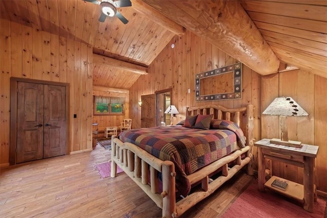 bedroom featuring wood walls, wooden ceiling, vaulted ceiling with beams, ceiling fan, and wood-type flooring