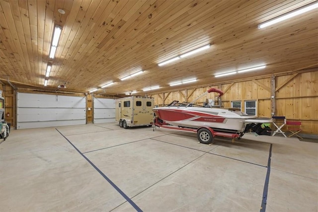 garage featuring wood walls and wooden ceiling