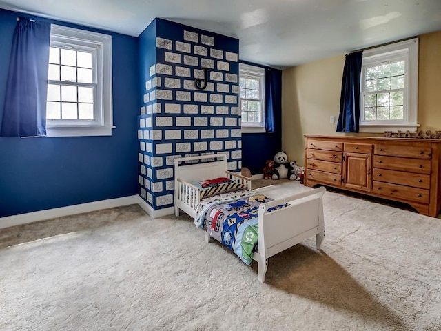 bedroom with carpet floors and multiple windows