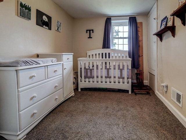 carpeted bedroom with a nursery area