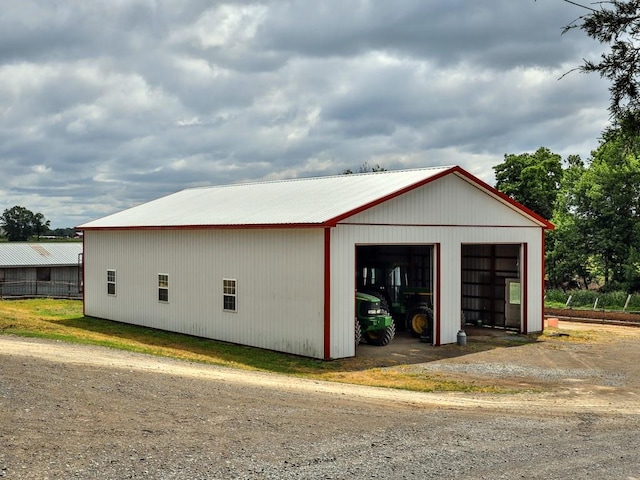 view of property exterior with an outbuilding and a garage