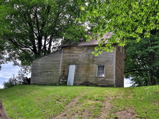 view of home's exterior with a lawn