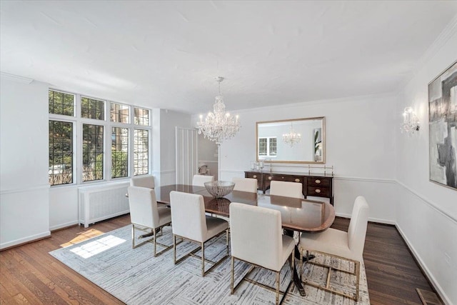 dining space with a notable chandelier, visible vents, radiator heating unit, ornamental molding, and wood finished floors