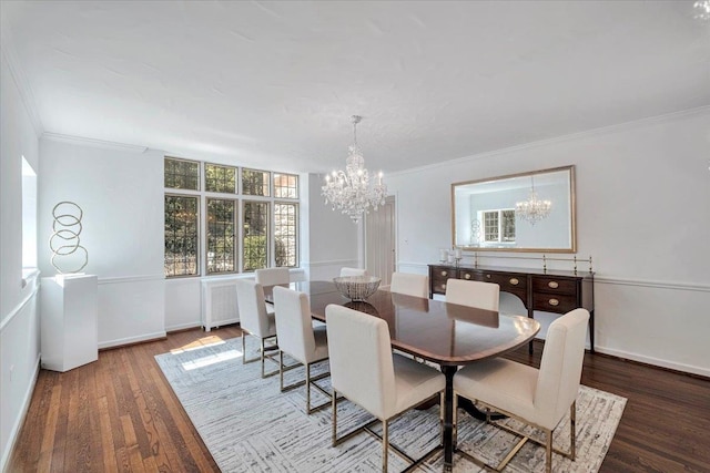 dining area featuring an inviting chandelier, crown molding, baseboards, and wood finished floors