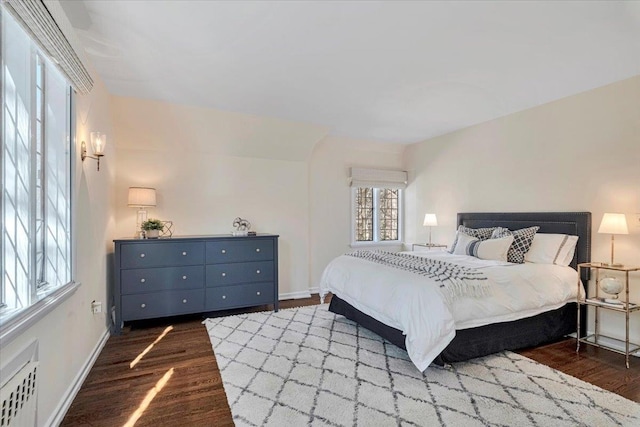 bedroom with baseboards and wood finished floors