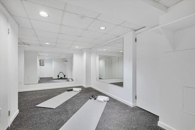 exercise area with baseboards, a drop ceiling, and recessed lighting