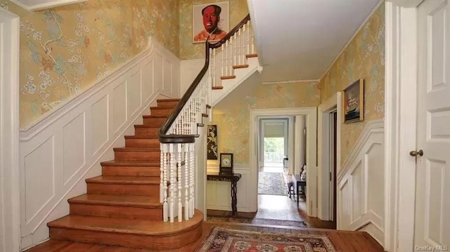 stairway with hardwood / wood-style floors