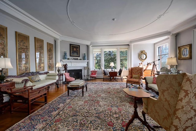 living room with hardwood / wood-style flooring, decorative columns, and ornamental molding