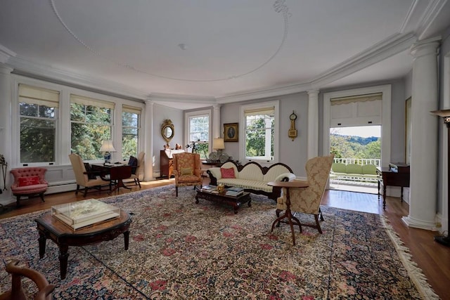 living room with hardwood / wood-style floors, a healthy amount of sunlight, and ornamental molding