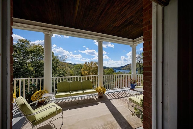 balcony with a mountain view and covered porch