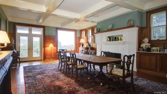 dining area with hardwood / wood-style flooring, beam ceiling, coffered ceiling, and french doors