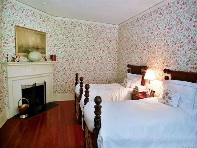 bedroom with dark hardwood / wood-style flooring and crown molding