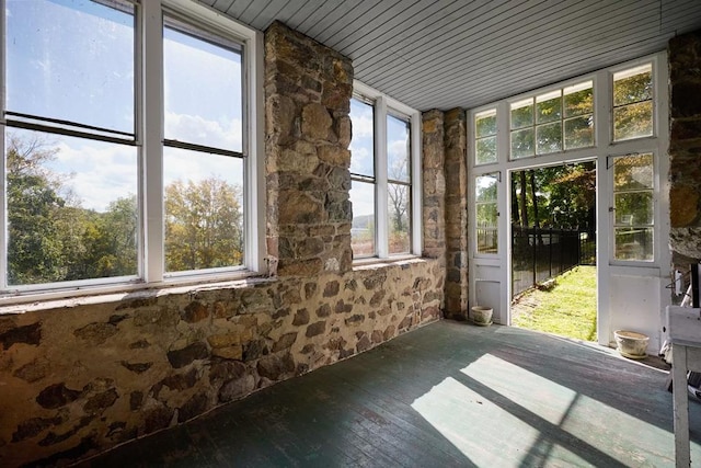 unfurnished sunroom with wooden ceiling