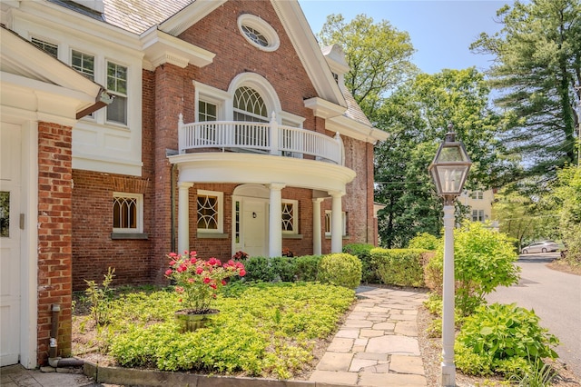 74 Tower Hill Loop, Tuxedo Park, NY 10987 - doorway to property with a balcony, brick siding, and a high end roof