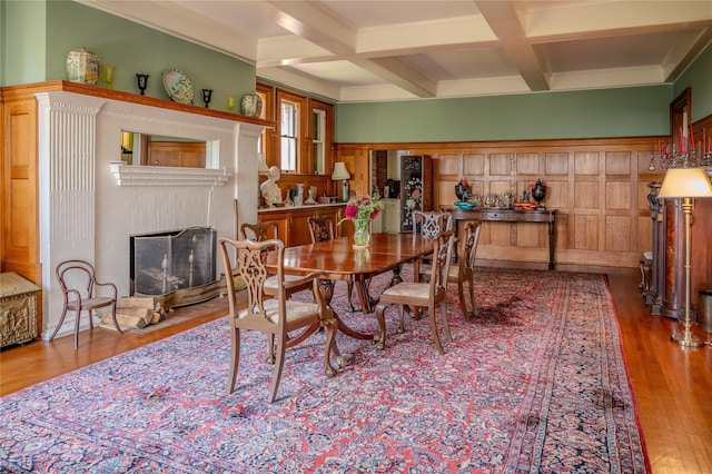 74 Tower Hill Loop, Tuxedo Park, NY 10987 - dining space featuring coffered ceiling, wood finished floors, beamed ceiling, crown molding, and a fireplace with flush hearth