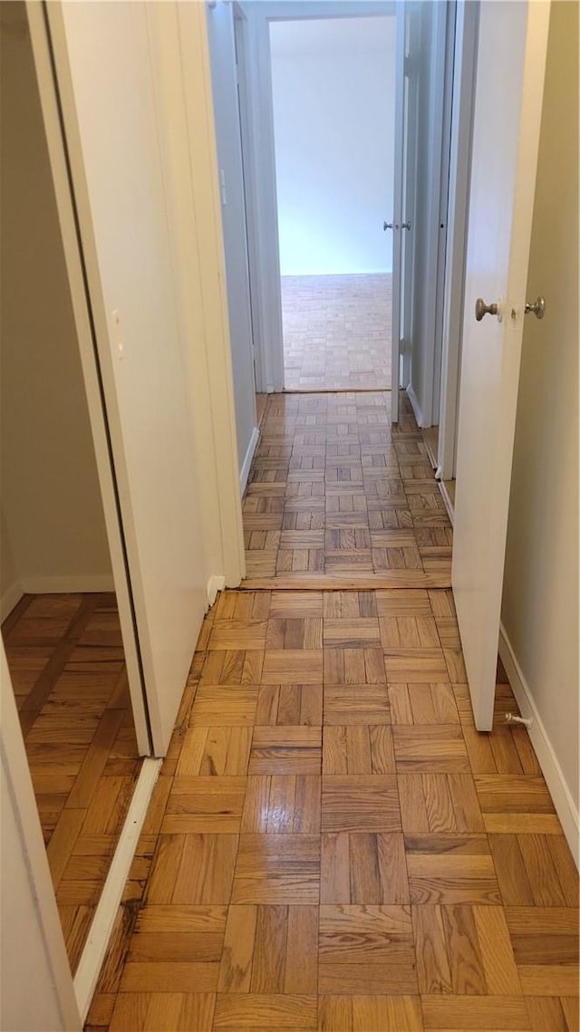 corridor with light parquet floors