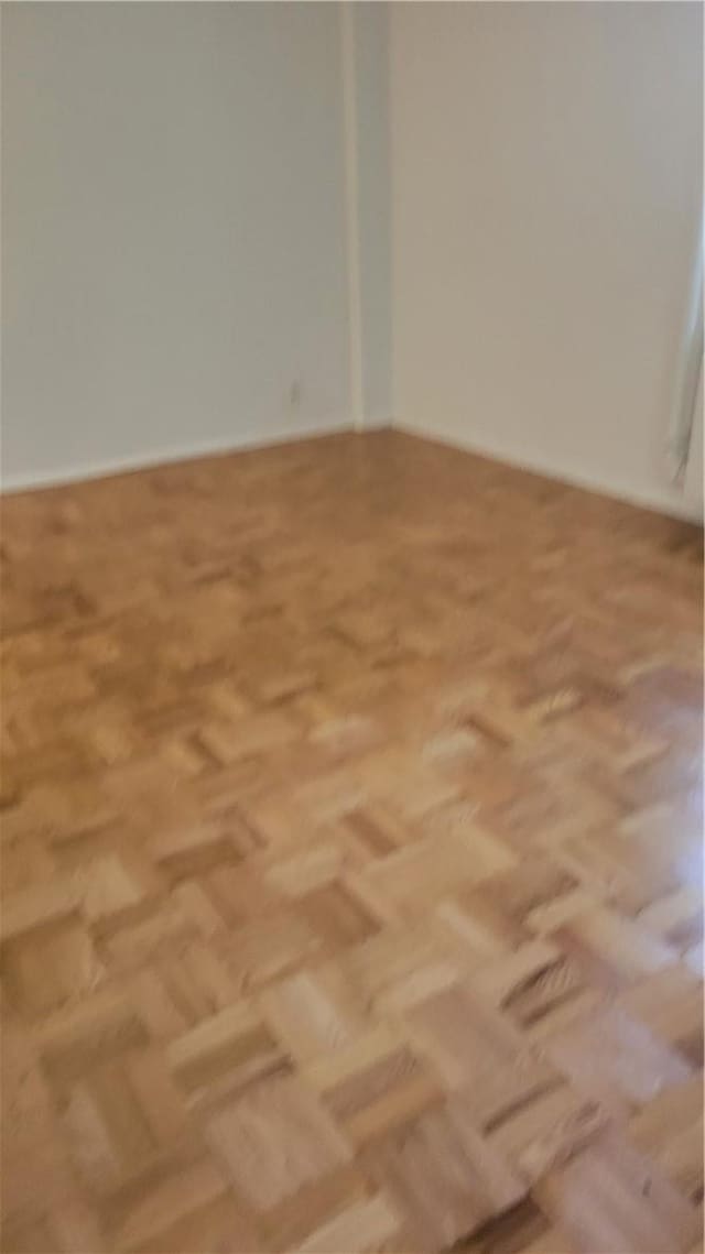 unfurnished room featuring light parquet floors