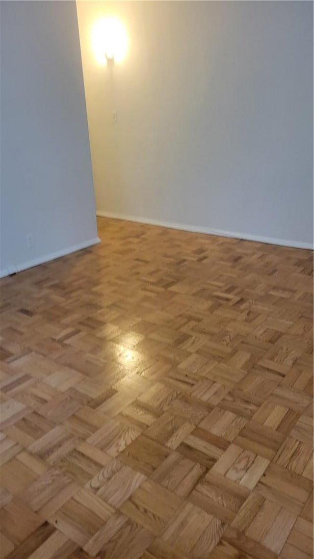 unfurnished room with light parquet floors