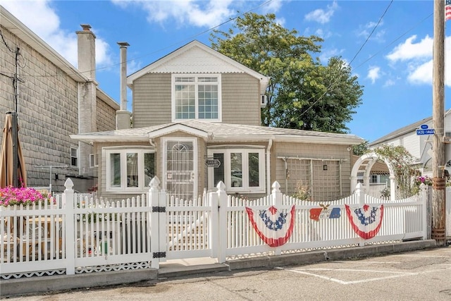 143D Edgewater Park Unit D, Bronx, NY 10465 - view of front facade featuring a fenced front yard and a shingled roof