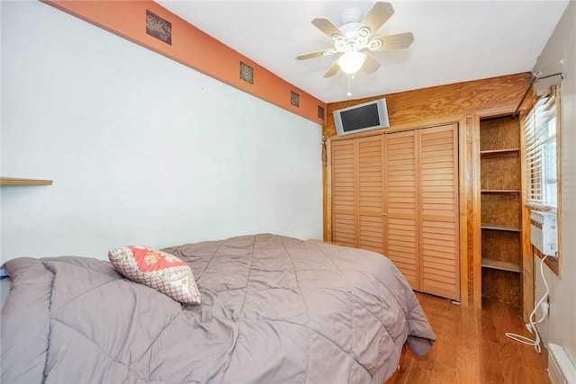 bedroom with a closet, ceiling fan, and light hardwood / wood-style flooring