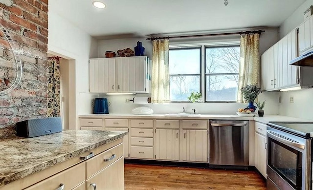 kitchen featuring sink, dark hardwood / wood-style flooring, white cabinetry, and stainless steel appliances