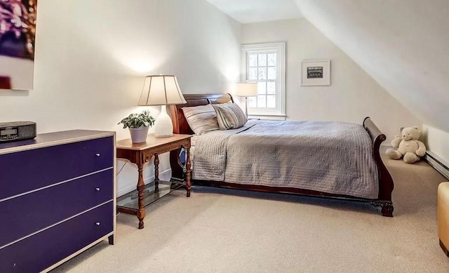 carpeted bedroom featuring lofted ceiling