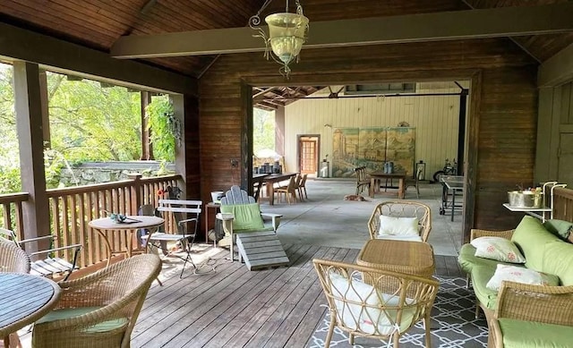 sunroom with lofted ceiling with beams, wooden ceiling, and an inviting chandelier