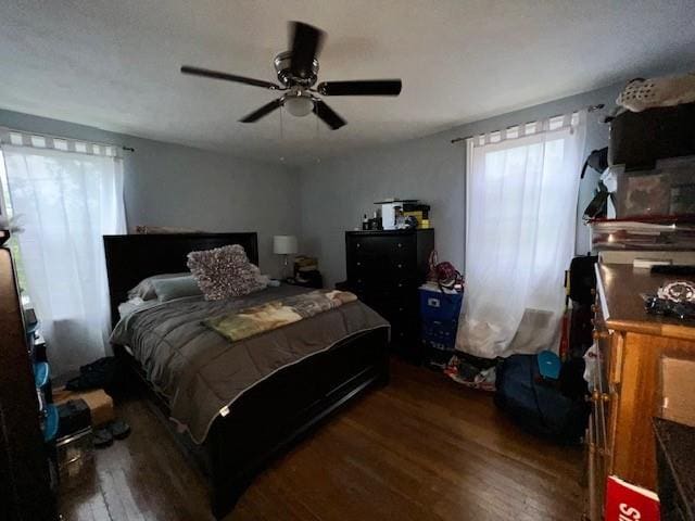 bedroom with ceiling fan and dark wood-type flooring