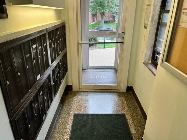 doorway to outside with mail boxes