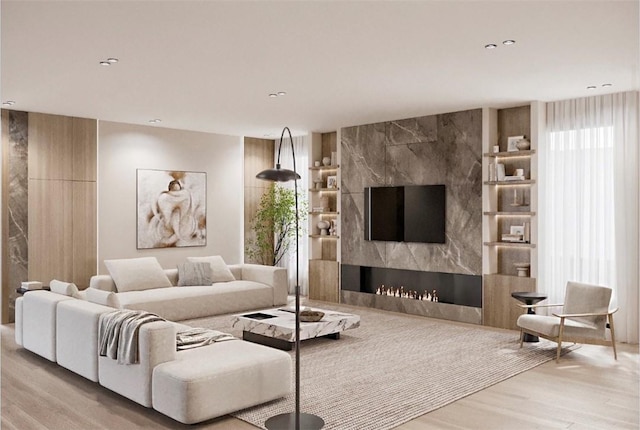 living room with a large fireplace and light wood-type flooring