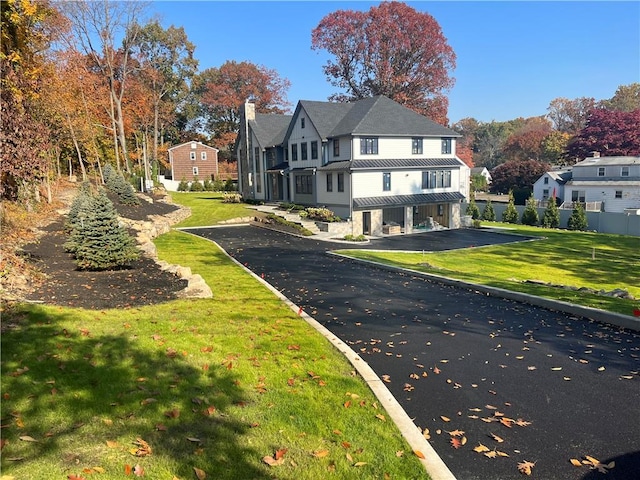 view of side of property with a yard