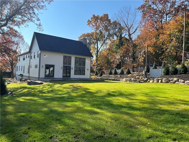 rear view of property with a yard