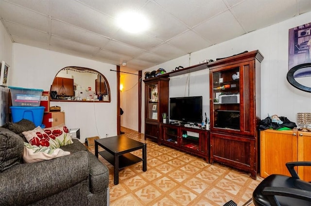 living room featuring a drop ceiling