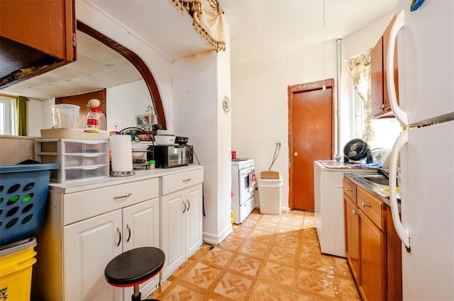 kitchen featuring white cabinets and white appliances