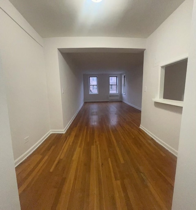 corridor with dark hardwood / wood-style floors