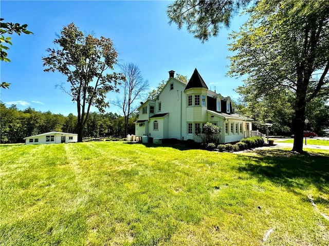 view of side of property featuring a yard