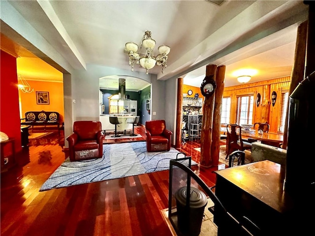 interior space featuring a notable chandelier, wood walls, and wood-type flooring