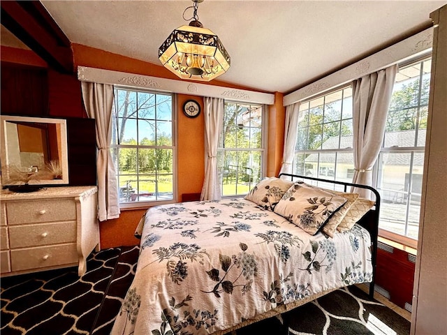 carpeted bedroom with lofted ceiling