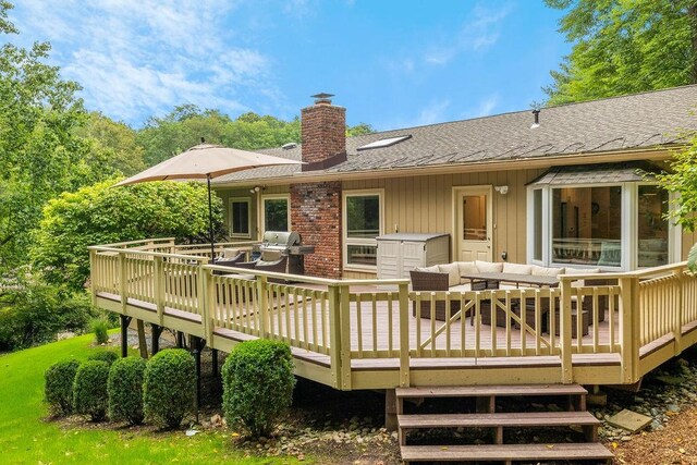 back of house with an outdoor living space and a deck