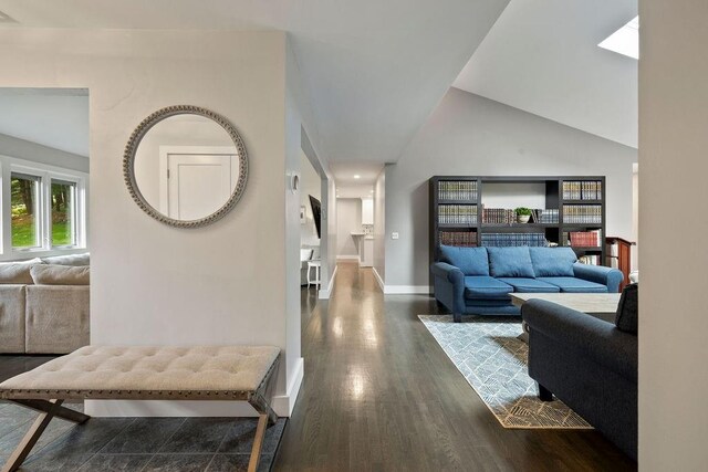 living room with dark hardwood / wood-style floors and high vaulted ceiling