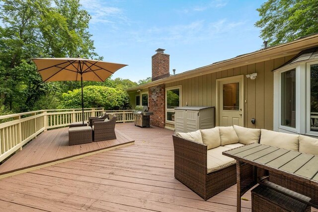 wooden terrace featuring outdoor lounge area and area for grilling