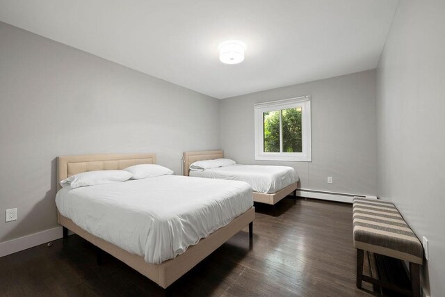 bedroom featuring a baseboard radiator and dark hardwood / wood-style floors