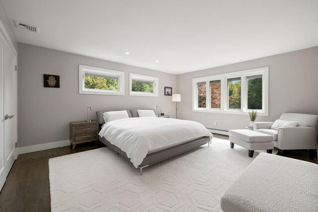 bedroom featuring hardwood / wood-style floors and baseboard heating