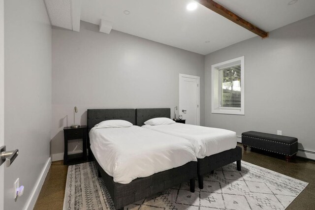 bedroom featuring baseboard heating and beamed ceiling