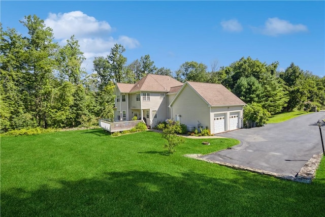 view of front of house featuring a garage and a front lawn